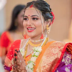 A candid moment of pure joy during the wedding rituals. I made sure her makeup was flawless and long-lasting, so she could enjoy every second without a worry. The red lip adds a perfect touch of bridal grace.