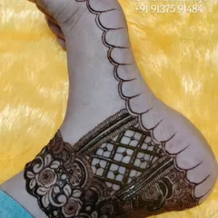 A close-up of the bridal foot design after the paste has been removed, showing the initial stain. The design includes a detailed ankle band with roses and a classic checkered filler.