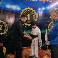 The moment a student receives their Black Belt is the culmination of years of hard work. I am tying the belt on Ishaan, marking a huge milestone in his martial arts journey.
