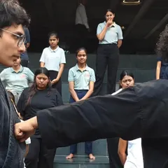 Students at ISBR Business School observe a demonstration of a basic punch. Understanding the mechanics of both attack and defense is a key part of learning effective self-protection.