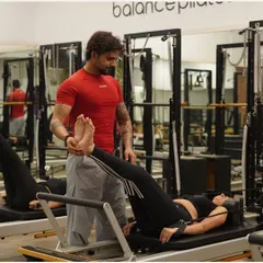 It's all about that personal touch. Here's one of our expert trainers making a hands-on adjustment to ensure perfect form. We're with you every step of the way to make sure you're moving safely and effectively.