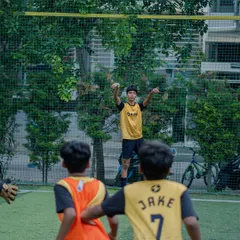 A young player jumps to head the ball during a practice session.