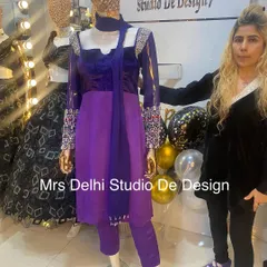 A look at one of our unique royal handwork traditional suits. This purple and blue outfit features intricate embellishments on the shoulders and sleeves, combining classic silhouettes with modern couture details.