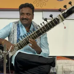 Welcome. I am Vijay Gonahalu, and I look forward to starting this musical journey with you. Here I am during a performance, ready to share the art of the sitar.