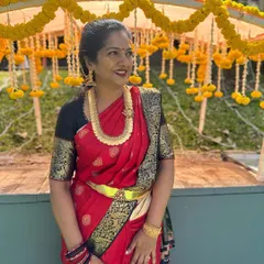 One of our best women, Pallavi, looking gorgeous and elegant in a classic red and black Kanjeevaram saree at a wedding.