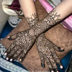 This intricate Indian henna design was created for a special client. It features a dense pattern of flowers, paisleys, and detailed linework for a classic bridal look.