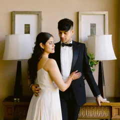 The epitome of classic elegance. Dressed in a timeless tuxedo and a beautiful white gown, they share a quiet, romantic moment. A perfect, formal pre-wedding portrait.