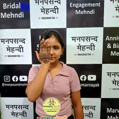 A student proudly displays her intricate palm design, a popular style for festivals like Vat Savitri. Our courses cover a wide range of traditional and modern patterns.