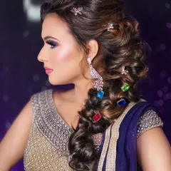 Hairstyling is a crucial part of a complete look. I teach my students how to create intricate and trendy styles like this voluminous messy braid, incorporating colorful accessories to make the final result pop for sangeet nights or cocktail parties.