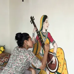 I love getting lost in the details of traditional Indian art. This is a close-up of me painting a musician figure, inspired by the delicate lines of Pichwai and Madhubani styles, for a resort wall in the Konkan region.