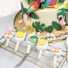 The matching cakesicles for the tropical party, decorated with tiny flamingos and pineapples.