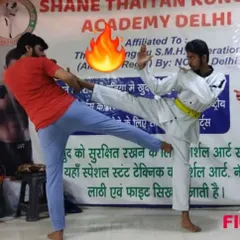 POWER in every kick. My student practices a side kick against an opponent during a live sparring session. We train for impact and effectiveness.