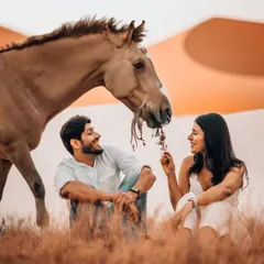 A whimsical pre-wedding moment shared with gentle giants. We love incorporating unique elements like this desert shoot with horses to make your photos stand out.