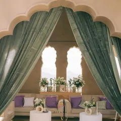 A view of the lounge through the elegant archway, framed by soft green drapes. The setup was designed to feel like a private, luxurious retreat high above the city.