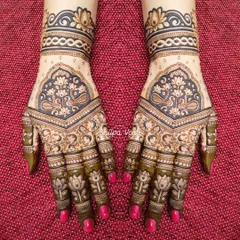 Symmetrical designs are a hallmark of professional mehndi. I teach how to map out and execute perfectly mirrored patterns, ensuring both hands create a single, cohesive piece of art.