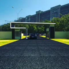 A wider view of our entrance gate concept for Greater Noida. This render shows how the gate integrates with the surrounding landscape and boundary walls, creating a cohesive and secure perimeter.