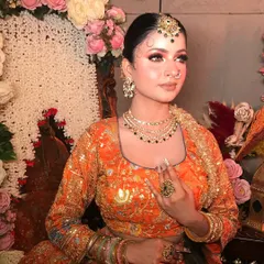 This portrait highlights the beautiful jewelry and the soft, radiant glow of the makeup.