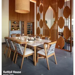 Craftsmanship is central to my work, as seen in this dining area at Kuttiyil House. The custom-designed wooden partition with its leaf motif and the large woven pendant light create a space that is both artistic and functional.