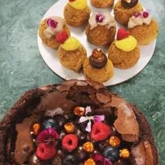 A beautiful pairing of my flourless chocolate cake topped with fresh berries and a plate of assorted choux pastries. This was part of a Rakshabandhan dessert order.
