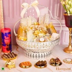 The Tejomay Hamper is a sparkling symphony of taste and tradition. The ornate silver basket is filled with an assortment of my finest sweets and savories, crafted for those who love to celebrate in style.