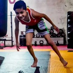 This young champion is practicing his agility and balance. Our kids' programs are designed to make fitness fun, helping them build a strong, healthy body and a sharp mind for the future.