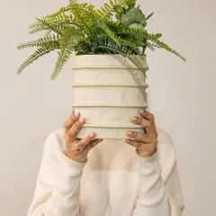 One piece, many moods. Our versatile Moonlit Ivory vase, shown here with lush green ferns, proves that your space should always tell your story, whether it's bold, minimal, or natural.