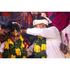 A close-up shot of a key wedding ritual. The groom is applying the kumkuma, and I framed this tightly to focus on the tradition and the expressions of the couple, surrounded by their loved ones.