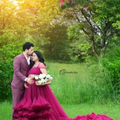 A tender moment between expecting parents, captured in our private outdoor garden. The vibrant magenta gown stands out beautifully against the lush greenery, and the golden hour light adds a warm, romantic glow to this pregnancy portrait.