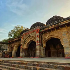 The beautiful arches of a monument in Lodi Garden, captured during the golden hour. The play of light and shadow highlights the intricate details of the architecture.