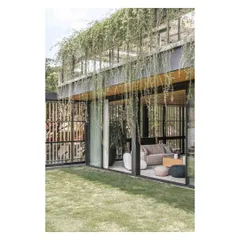 The cascading greenery from the upper level creates a natural curtain, adding privacy and a lush, tropical feel to the terrace lounge.