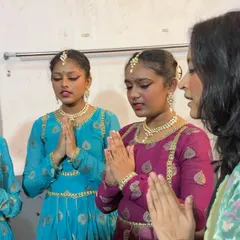 A quiet moment of guidance before a performance. Here I am with two of my young students, sharing a few last words of encouragement.