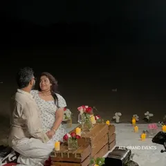 Capturing the happy couple during their private beach proposal. Our setup provides a beautiful and intimate setting for photos, with the soft glow of candles and the ocean in the background.