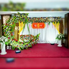 Another perspective of our crescent moon floral design for a naming ceremony. This setup combines a variety of colorful flowers with traditional yellow drapes for a vibrant celebration.