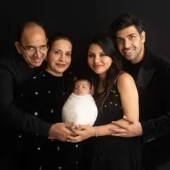 Welcoming a new member with a multi-generational portrait. Capturing three generations together with their newborn is a powerful way to document your family's growing legacy.