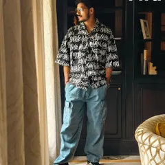 A full-body shot for H&M and Myntra FWD, featuring a bold graphic shirt and cargo pants. The indoor, moody setting shows how I can create a high-fashion feel in a lifestyle context.