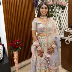 Ready for the party. This client looks stunning in a multi-color pastel lehenga, complete with matching jewellery, perfect for a sangeet or reception.
