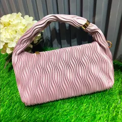 A modern and stylish pink handbag with a ruched handle. This is a great accessory for a daytime event or a cocktail party.