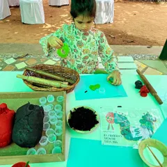Inspired by "The Very Hungry Caterpillar," this child is using homemade playdough and natural materials to create their own caterpillar. This activity is great for storytelling and fine motor practice.