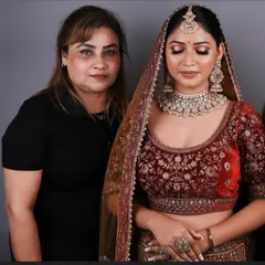 One of my talented students standing proudly with her model after completing the bridal makeup exam. This is the moment their hard work pays off.