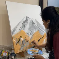 In the zone, painting an abstract mountain landscape. I use a palette knife here to apply thick layers of paint and create a rugged, textured surface.