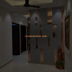A stylish partition wall made of grey panels and rose-gold mirror strips. It separates the space while also serving as a beautiful decorative feature.