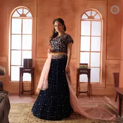 Experience the latest designer trends without the hefty price tag. This navy blue velvet lehenga with a contrasting pink dupatta is a chic and elegant choice for a winter wedding.