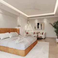 This spacious bedroom includes a separate seating area, making it a true retreat. The design uses a consistent palette of warm neutrals and natural textures to create a cohesive and tranquil environment.