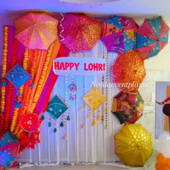 Another angle of our Lohri party decor, showing the 'Happy Lohri' sign and the rich textures of the colorful umbrellas and drapes.