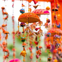 We used traditional Rajasthani decor elements, like these colorful hanging umbrellas and elephant tassels, to create an authentic and festive atmosphere for this Mehendi celebration.