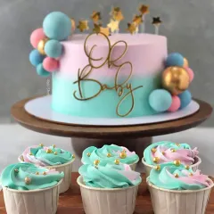 This "Oh Baby" shower cake is a perfect example of my custom, fondant-free work. The pastel pink and blue ombre effect is created with delicate whipped cream, complemented by matching cupcakes for a complete dessert table.