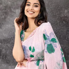 A bright and cheerful look featuring a pink and green floral saree. The styling is fresh and youthful, perfect for daytime events or a modern take on ethnic wear.