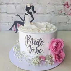 An elegant "Bride to be" cake featuring a silhouette topper and fresh pink roses. This is one of our popular non-fondant designs, perfect for a chic bachelorette party.