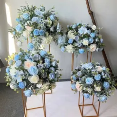 A set of four floral arrangements on gold stands, featuring a mix of blue and white artificial roses. These are perfect as coordinated decor for events, placed on tables or at key points around a venue.