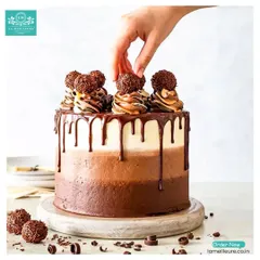 This is for the ultimate chocolate lover. My triple-layer chocolate ombre cake features varying shades of chocolate frosting, a decadent dark chocolate drip, and is topped with Ferrero Rocher truffles and delicate chocolate swirls.
